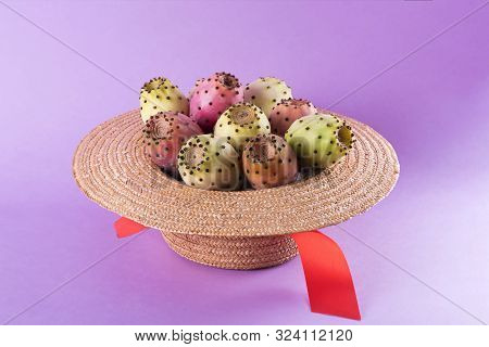 Opuntia Fruit In A Straw Hat On A Trendy Purple Background. Prickly Pear Or Fichi Dindia Salento, Pu