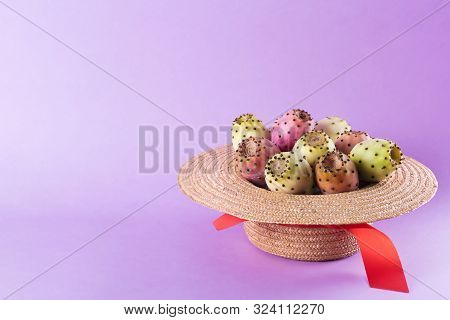 Opuntia Fruit In A Straw Hat On A Trendy Purple Background. Prickly Pear Or Fichi Dindia Salento, Pu