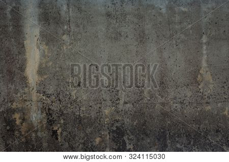 Abstract Texture Of Old Grey Wall With Cracks, Scratches And Yellow Moss. Dark Background