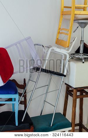 Lots Of Multicolored Chairs In The Interior Of The White Room