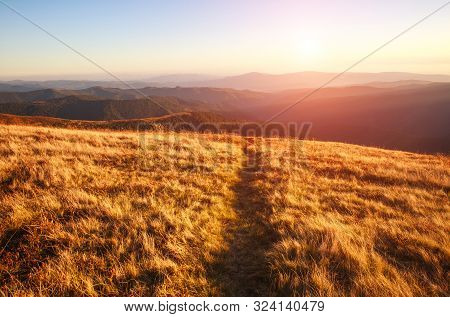 Mountain Trail, Hiking Road On Sunset Sky Background, Travel And Toursm In The Wild Nature