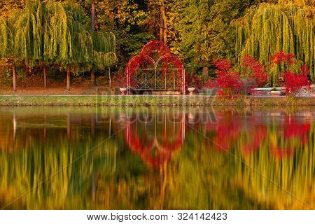Evening In The Autumn City Park.
Trees Are Reflected In The Pond. Ukraine, Kyiv. 