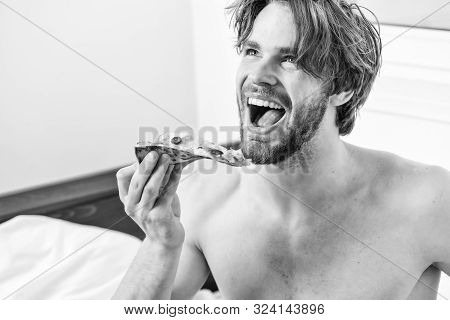 Cropped Image Of Shirtless Sexy Man With Pizza On Bed. Man Bearded Handsome Guy Eating Cheesy Food F