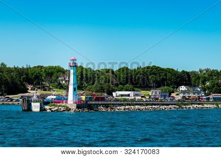 Mackinac Island Mi /usa - July 9th 2016: St Ignace Lighthouse At The Harbor Shot On A Sunny Summer D