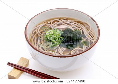 Japanese Kake Soba Noodles In A Ceramic Bowl On White Background