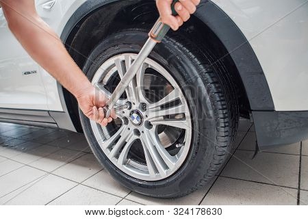 Car Repair, Bmw Advertising, Moscow, 1.11.2018: Car Repair: Wheel Replacement Closeup. Mechanic Scre