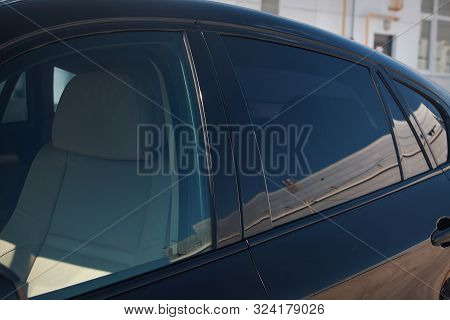 Tinted Black Car Windows That Reflect The Glass Ceiling