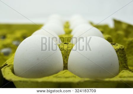 White Chicken Eggs On Their Paperboard Container.