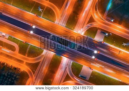 Intersection Of Two Major Highways, Intersection Under A Bridge, Night Aerial Top View Of Street Lig