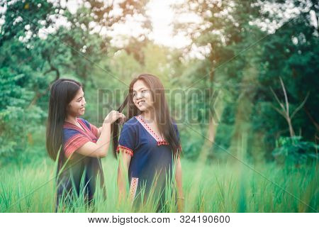 Portrait Of Young Girls Enjoy Playing In The Mist Of Foresst Outdoor At Countryside Of Thailand