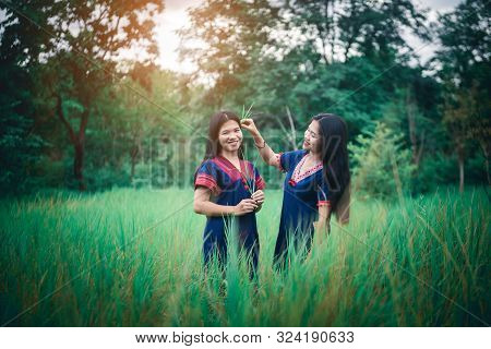 Portrait Of Young Girls Enjoy Playing In The Mist Of Foresst Outdoor At Countryside Of Thailand