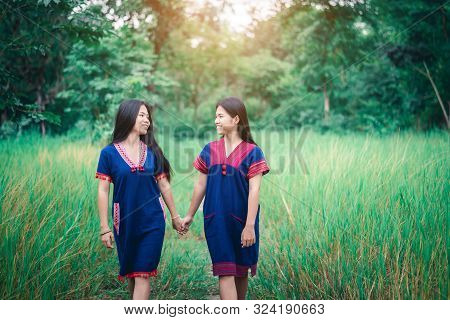 Portrait Of Young Girls Enjoy Playing In The Mist Of Foresst Outdoor At Countryside Of Thailand