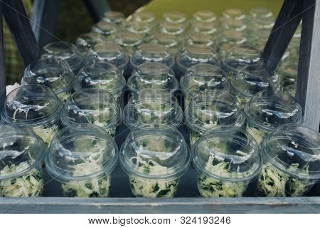 Organic Veggies In Cups To Go.close-up Of Loads Of Plastic Cups Filled With Chopped Vegetables And S