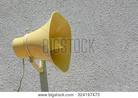 Yellow Plastic Loudspeaker On The Street On Wall. The Siren Of Air Alarm.