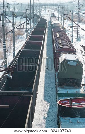 Vertical Banner Of Rail Cars Loaded With Coal Being Transported From Nearby Mines To Power Plants In