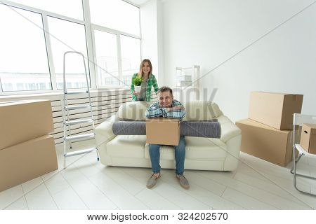 Relocation, Real Estate And Moving Concept - Young Cheerful Couple Moving Into Their New Home