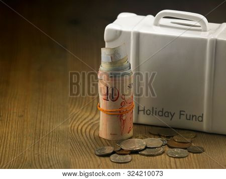 lugagge shape saving jar on the wooden table