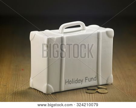 lugagge shape saving jar on the wooden table