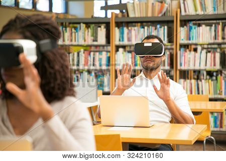 Multiethnic Group Of Students Using Vr Gadgets For Studying. Man And Woman In Virtual Reality Headse