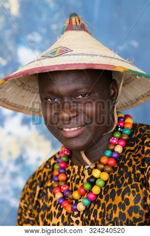Closeup Portrait Of Handsome African Man In Traditional Fulani Hat And Colorful Clothes