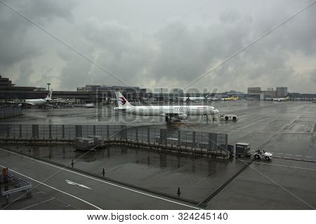 Aircraft Boeing And Japanese People Prepare Plane For Take Off And Landing On Runway While Raining I