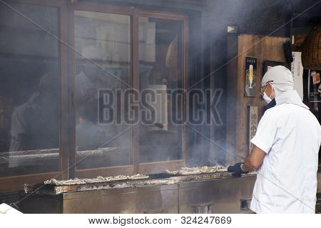 Japanese People Cooking Kabayaki Or Cooked Grilled And Roasted Eel Fish With Sweet Sauce In Local Re
