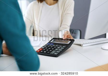 Accountant Checking Financial Statement Or Counting By Calculator Income For Tax Form, Hands Close-u
