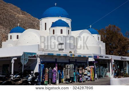 Santorini, Greece - April, 2018: The Stores Next To The Church Of Holy Cross In The Central Square O