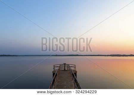 Landscape Of The Sunset Reflaction Water In The River With Floodgate In The Reservoir At Rural Thail