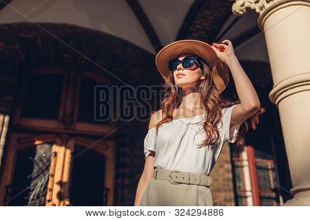 Fashion Model. Outdoor Portrait Of Tourist Woman Enjoying Sightseeing In Lviv. Girl Looking At Ancie