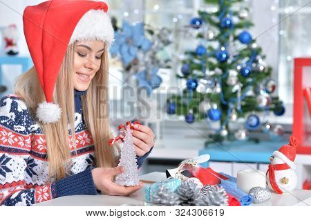 Portrait Of Cute Smiling Woman Preparing For Christmas