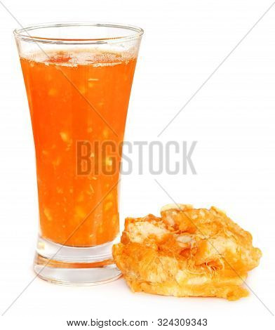 Medicinal Bael Fruit With Juice In A Glass Over White Background