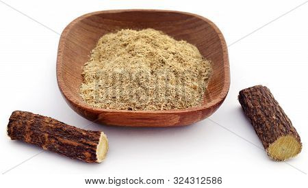 Liquorice With Powder In A Bowl Over White