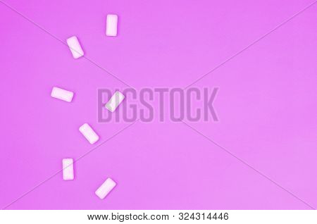 A Few Chewing Gums Lie On Texture Background Of Fashion Pastel Purple Color Paper
