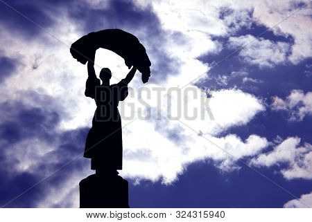 Silhouette. Statue On A Building In The City Of Kiev. Ukraine. Exhibition Of National Economy.