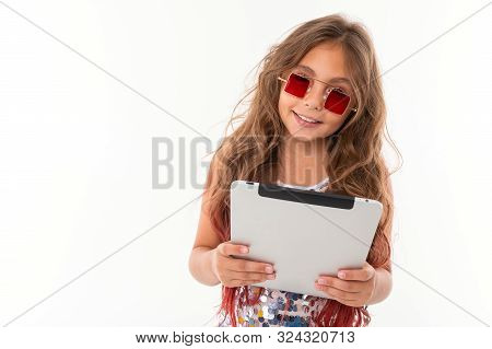 Smiling Girl In Square Red Sunglasses Holding Tablet Screen Against White Background Isolated