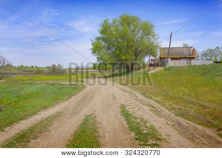 Spring Landscape. Country Road Passing By The Village.