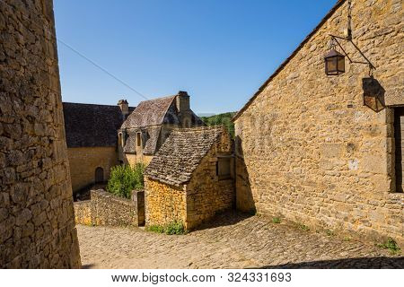 The medieval town of Beynac rising on a limestone cliff above the Dordogne River. France, Dordogne department, Beynac-et-Cazenac