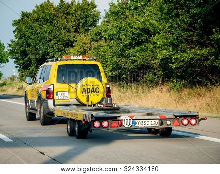 Germany - Aug 29, 2019: Rear View Of Adac Mitsubishi Pajero Suv In Vivid Yellow Color With Cargo Tra