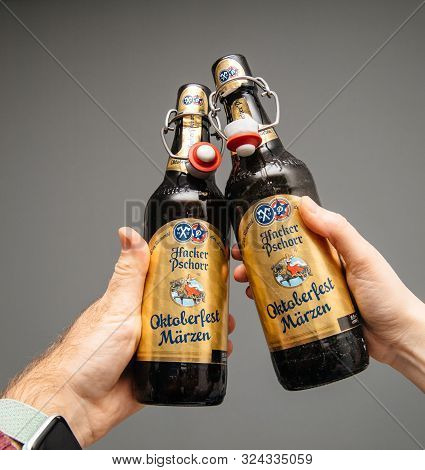 Munich, Germany - Mar 3, 2019: Close-up Of Man And Woman Hand Holding Drinking Open Bottle Of Tradit