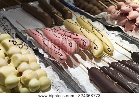 Fruits Bananas, Strawberries, Nuts, Apples, Peaches Drenched In White And Dark Chocolate.