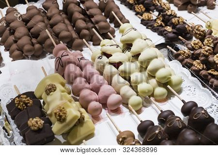 Fruits Bananas, Strawberries, Nuts, Apples, Peaches Drenched In White And Dark Chocolate.