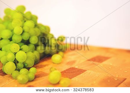 Fresh Green Grape On The Wooden Cutting Board