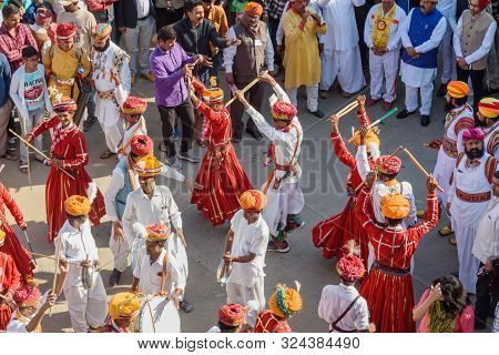 Jaisalmer, India - February 17, 2019: Ceremonial Procession Indian Men Dancing In Traditional Clothi