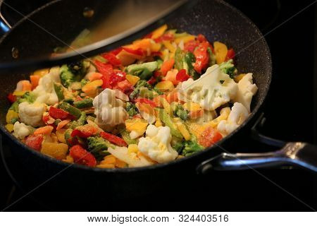 Frozen Vegetables, Including Pepper Broccoli And Cauliflower Being Cooked