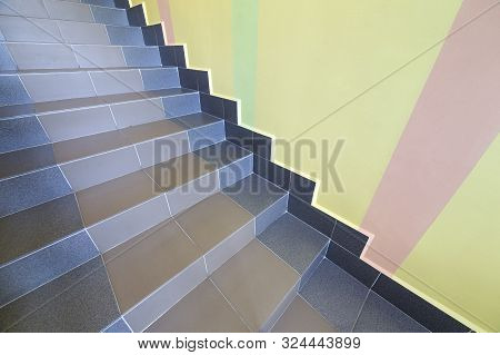 Wide Staicase Covered With Ceramic Tiles Indoors In A House Interior.
