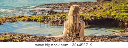 Young Woman Tourist On Pantai Tegal Wangi Beach Sitting In A Bath Of Sea Water, Bali Island, Indones