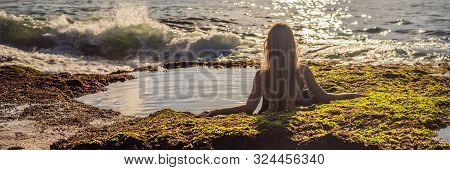 Young Woman Tourist On Pantai Tegal Wangi Beach Sitting In A Bath Of Sea Water, Bali Island, Indones