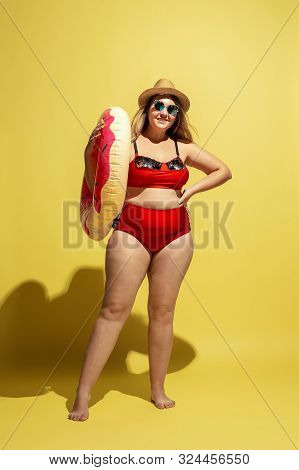 Young Caucasian Plus Size Female Models Preparing For Beach Resort On Yellow Background. Woman In Re