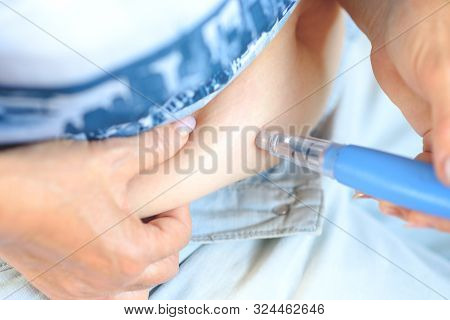 Elderly Woman Giving Herself Injection Against Osteoporosis In Abdomen. Old Senior Woman Used Pen In